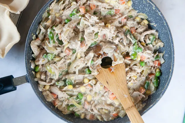 Thickened chicken pot pie filling in a skillet