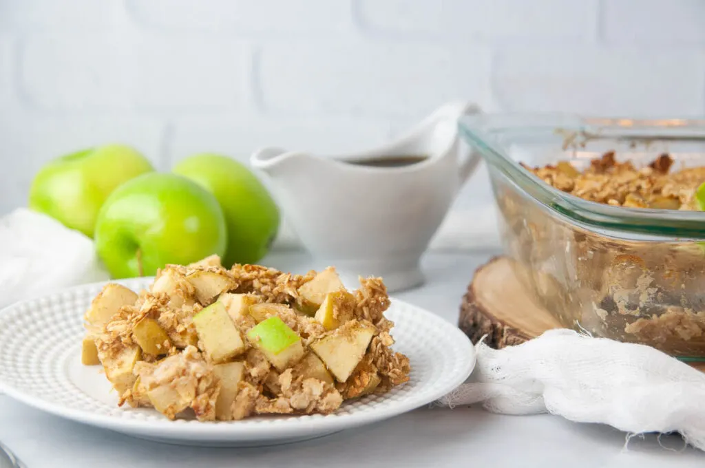 Baked Apple Oatmeal drizzled with maple syrup makes a hearty, wholesome breakfast.