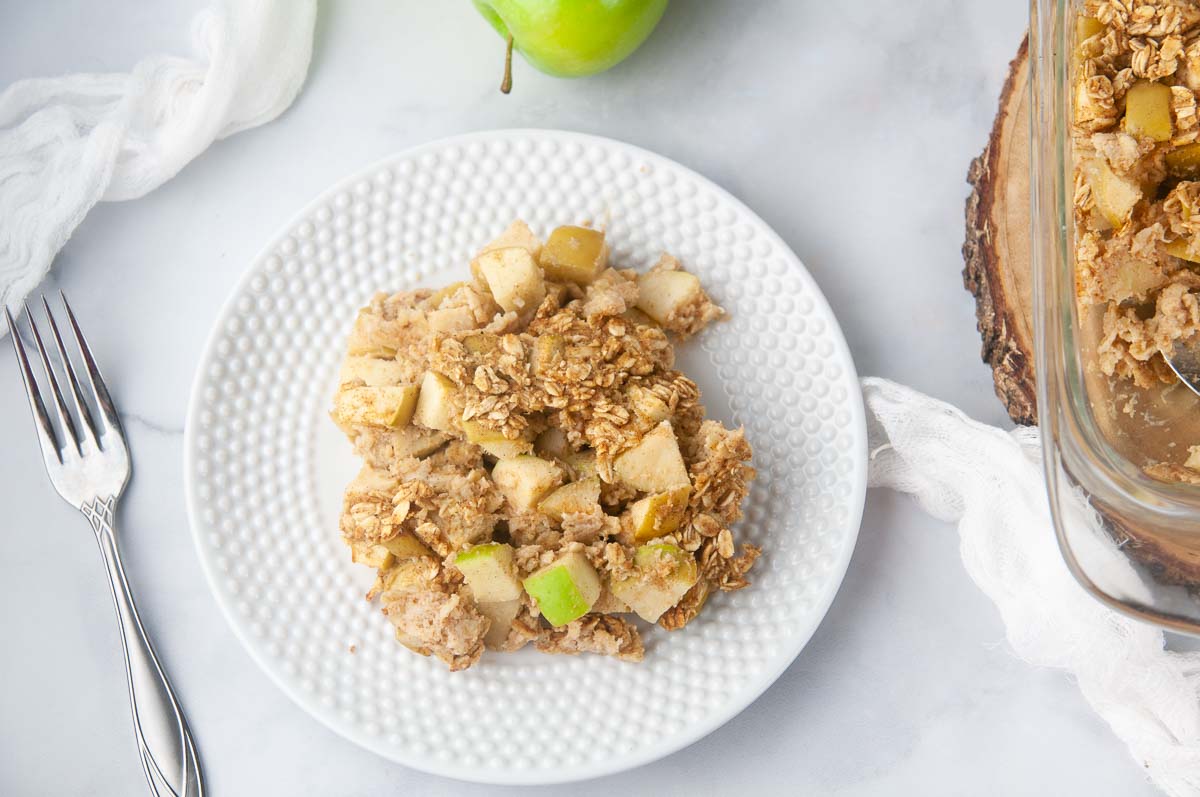 Baked Apple Oatmeal drizzled with maple syrup makes a hearty, wholesome breakfast.