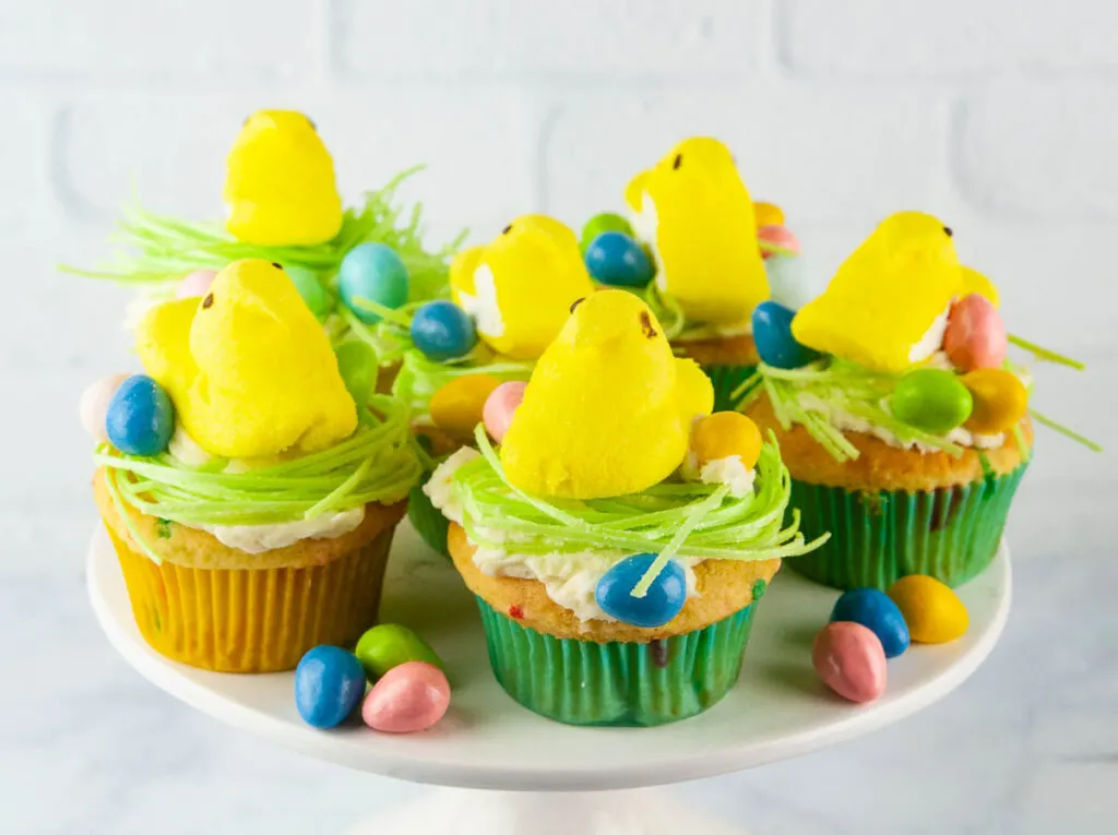 Easter Peeps Cupcakes look like sweet little egg nests with fluffy yellow chicks. Perfect project for the kids.