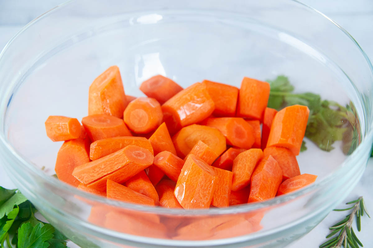 Peel the carrots and cut them into equal sized pieces.