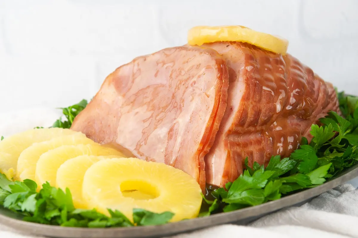 Instant Pot Ham with Honey Glaze is a delicious holiday dinner main dish you can make any time. This foolproof recipe produces results that rival Honey Baked ham but for a fraction of the cost and in no time at all.