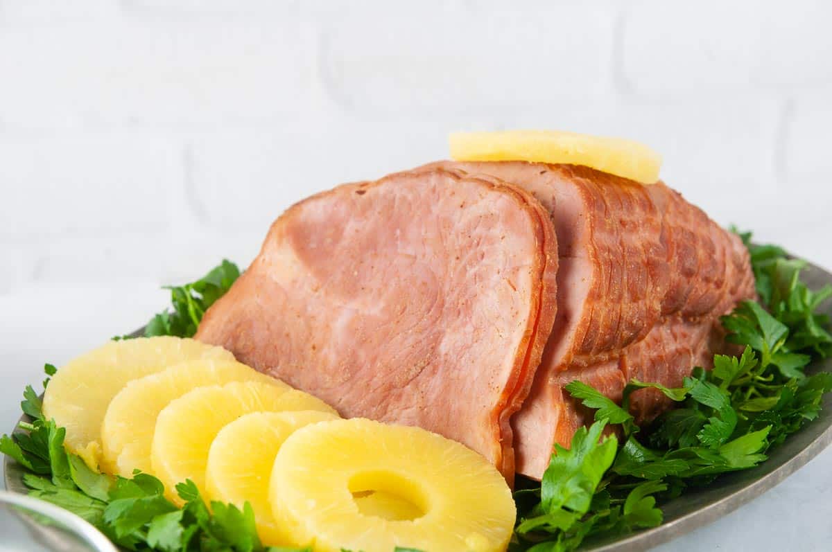 Instant Pot Ham with Honey Glaze is a delicious holiday dinner main dish you can make any time. This foolproof recipe produces results that rival Honey Baked ham but for a fraction of the cost and in no time at all.