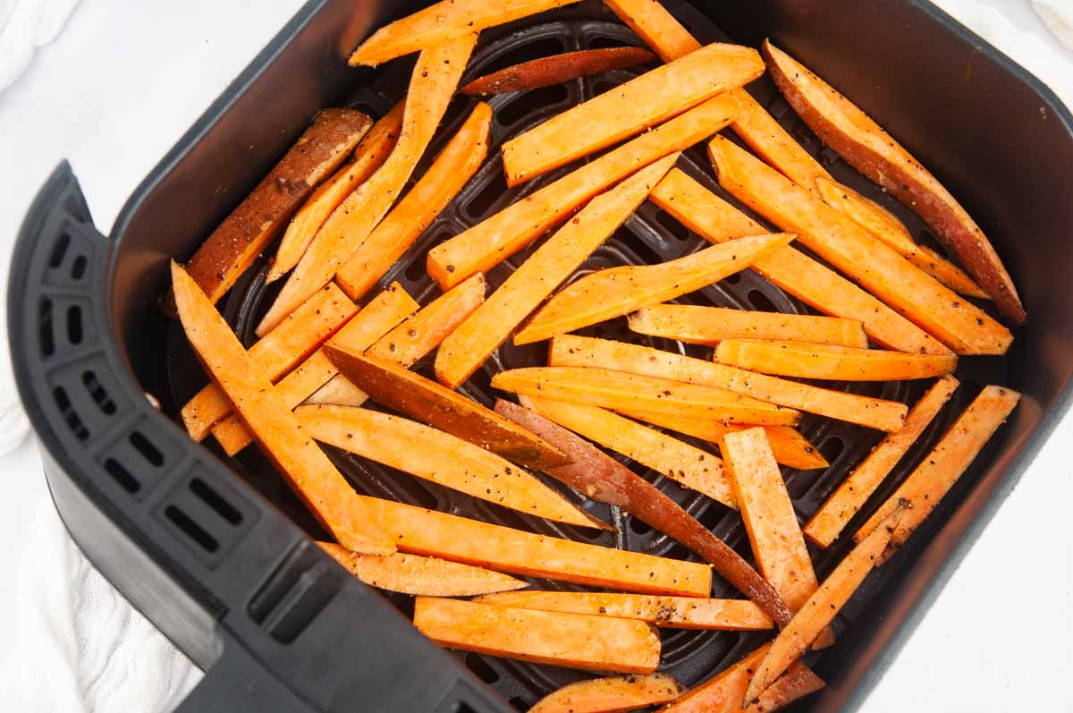 Put the sweet potato fries in the basket of the air fryer, trying to minimize overlapping.