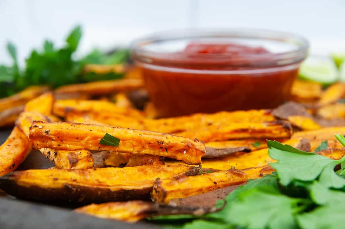 Easy air fryer sweet potatoes are the perfect thing to dunk into ketchup.