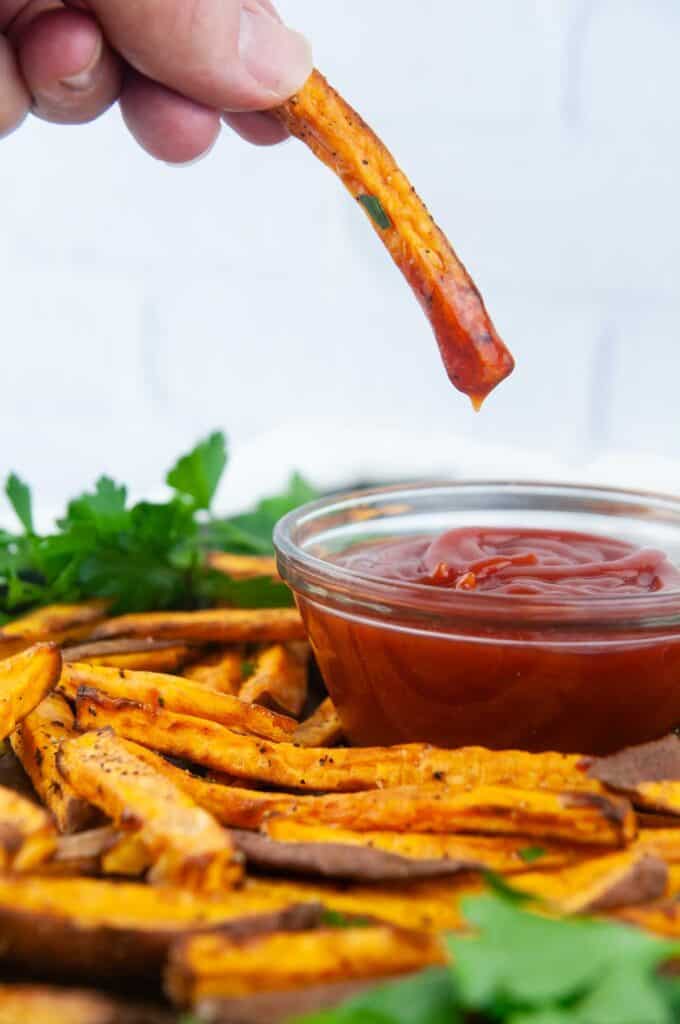 Easy air fryer sweet potatoes are the perfect thing to dunk into ketchup.