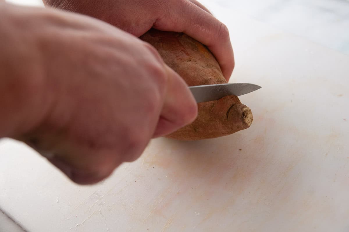 Cut the pointed ends off of the sweet potato.