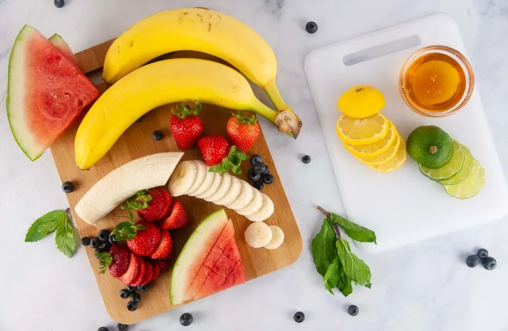 Ingredients for Red, White and Blue Fruit Salad: bananas, strawberries, blueberries, watermelon, lemon juice, lime juice and honey
