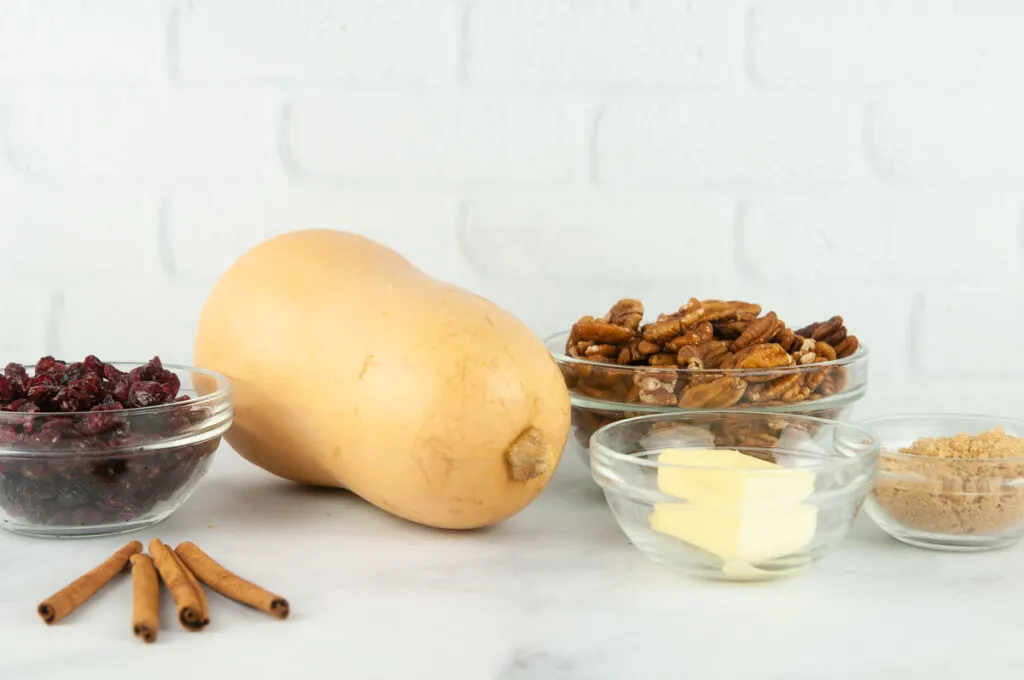 Brown sugar butternut squash ingredients: brown sugar, butternut squash, cinnamon, butter, pecans and craisins