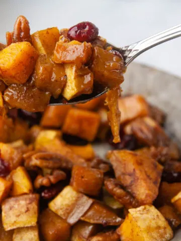 A spoon of butternut squash over a platter