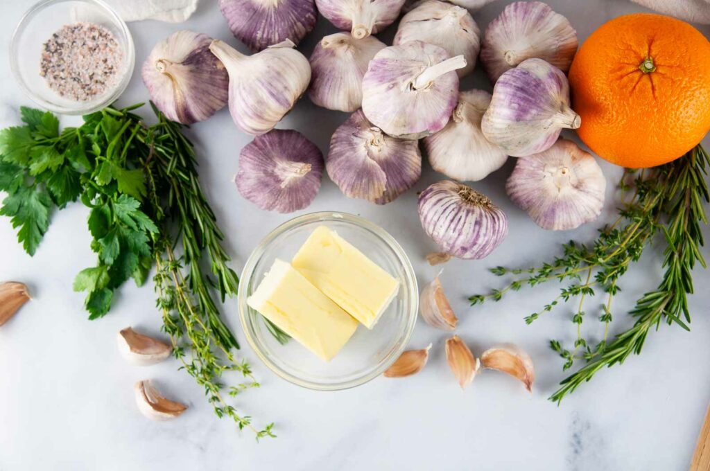 Ingredients to make the best turkey baste ever- garlic, butter, herbs, and citrus