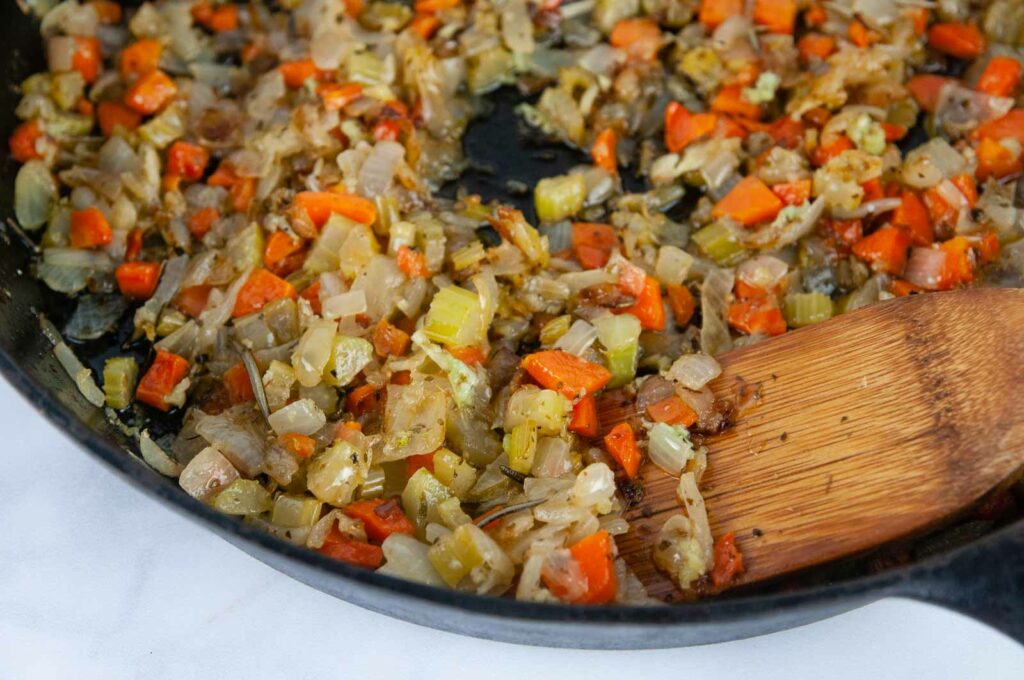 Carrots, celery, and onion get cooked with butter, oil and herbs to make a vegetarian stuffing base.