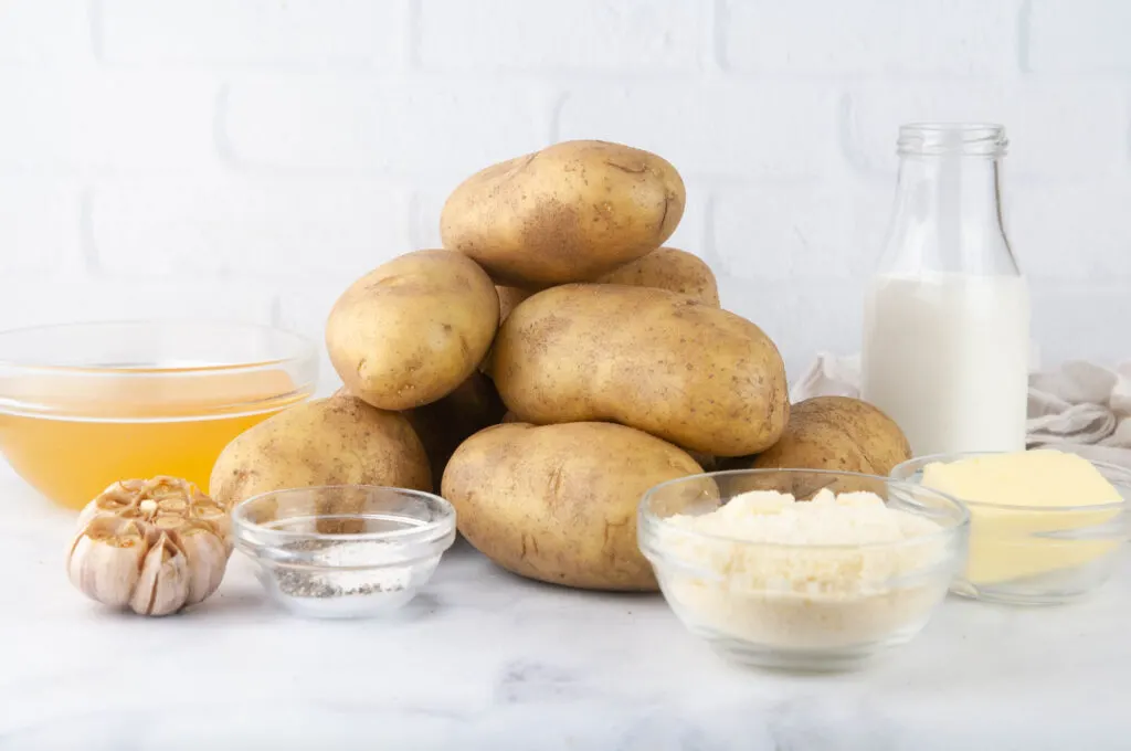 Ingredients for Roasted Garlic Mashed Potatoes: Potatoes, Heavy Cream, Broth, Parmesan Cheese, Roasted Garlic, Spices