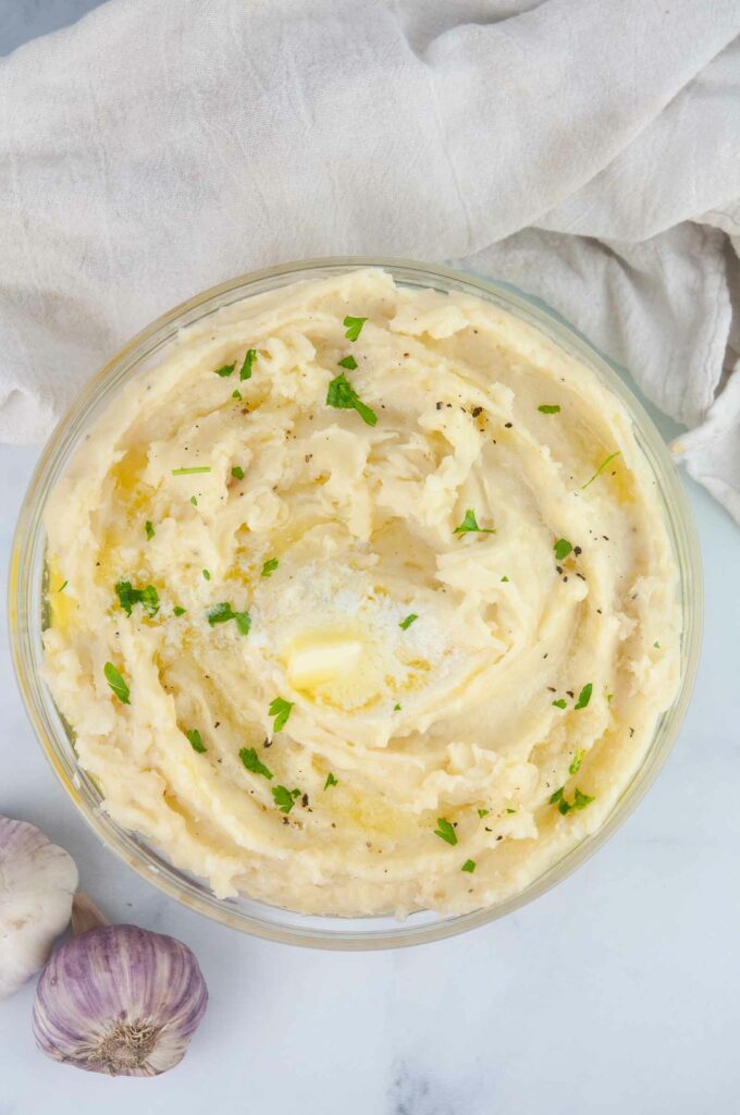 Fluffy roasted garlic mashed potatoes are buttery and a perfect side for a holiday dinner or Sunday roast.