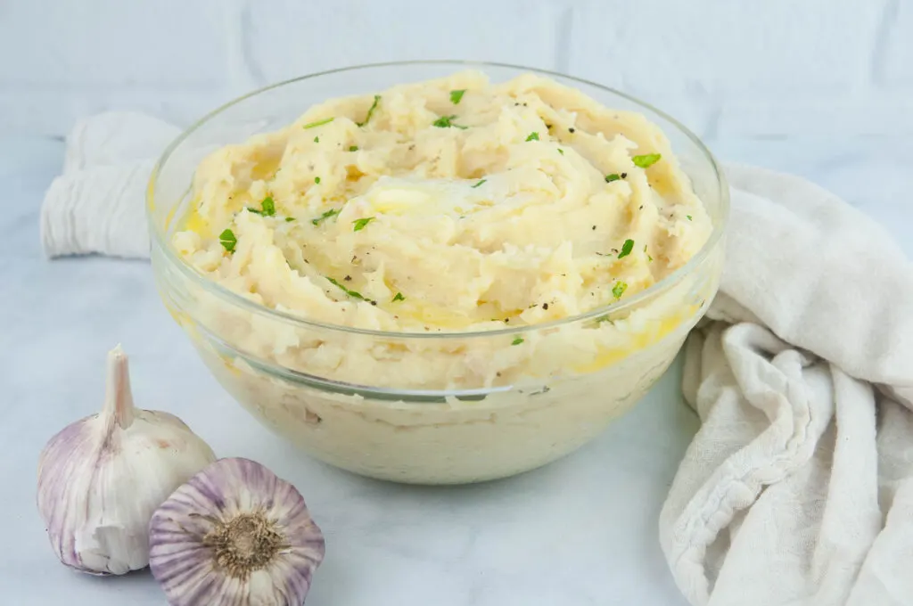 Fluffy roasted garlic mashed potatoes are buttery and a perfect side for a holiday dinner or Sunday roast.