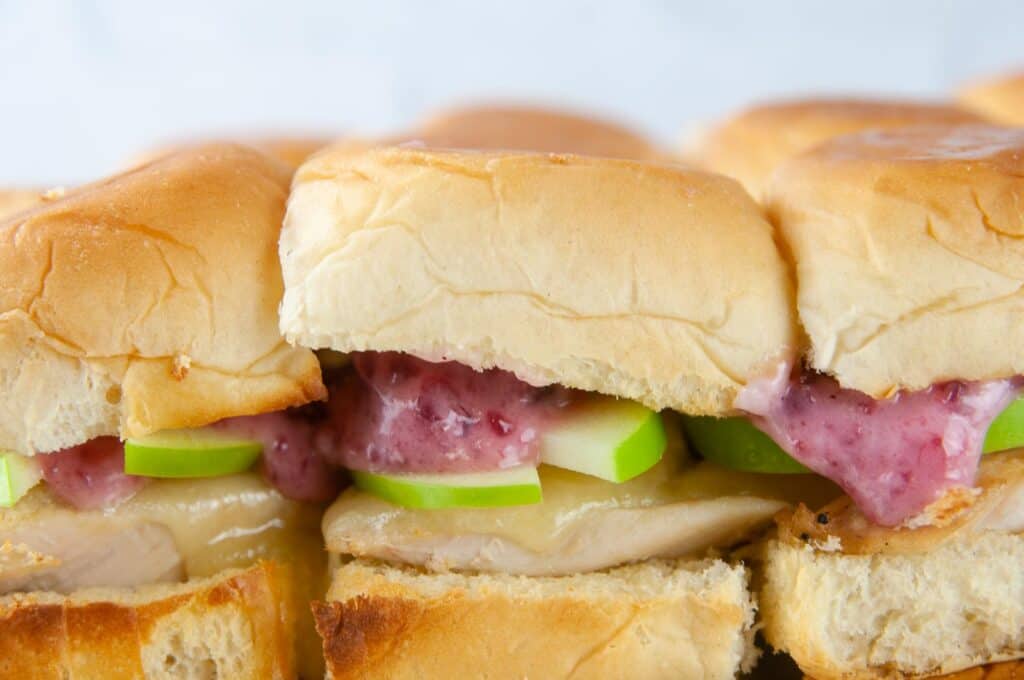 Turkey sliders on Hawaiian rolls are loaded with cranberry mayo, sharp cheddar and tart apple slices for a yummy way to use up holiday leftovers.