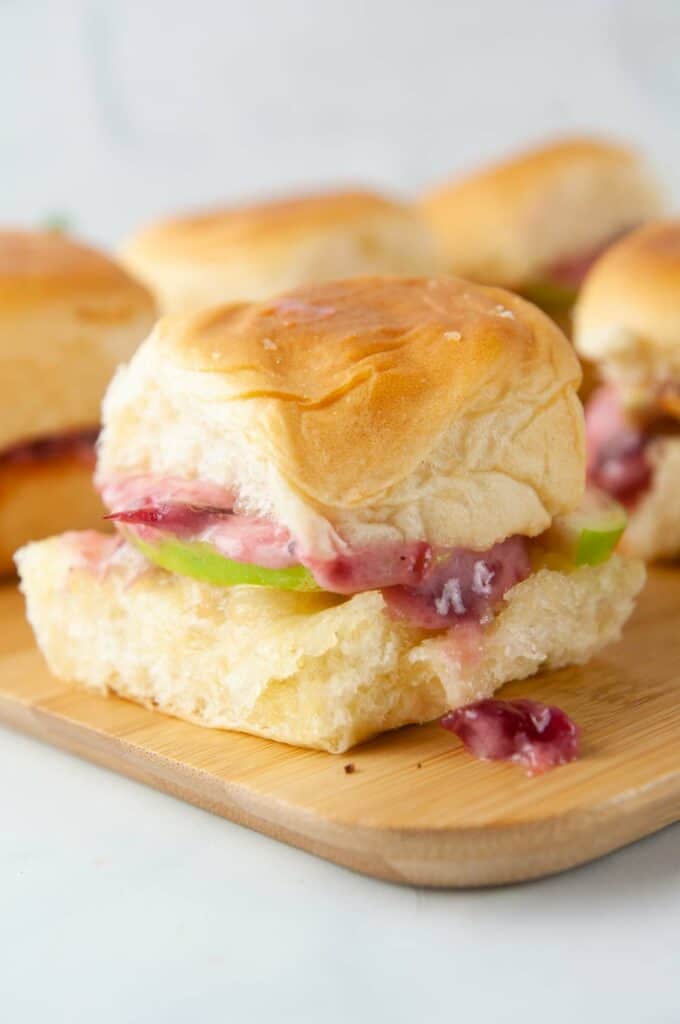 Turkey sliders on Hawaiian rolls are loaded with cranberry mayo, sharp cheddar and tart apple slices for a yummy way to use up holiday leftovers.