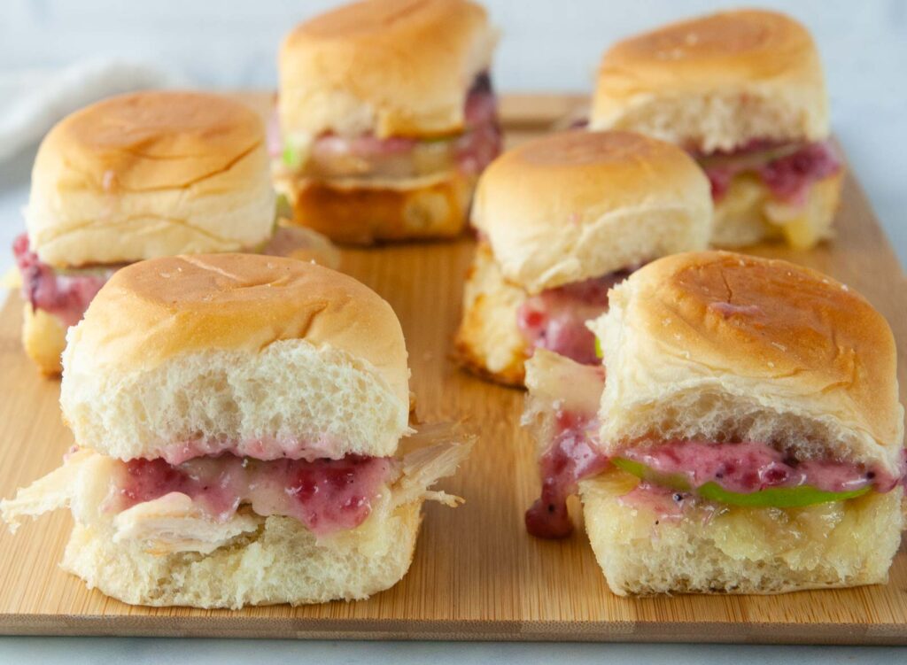 Turkey sliders on Hawaiian rolls are loaded with cranberry mayo, sharp cheddar and tart apple slices for a yummy way to use up holiday leftovers.