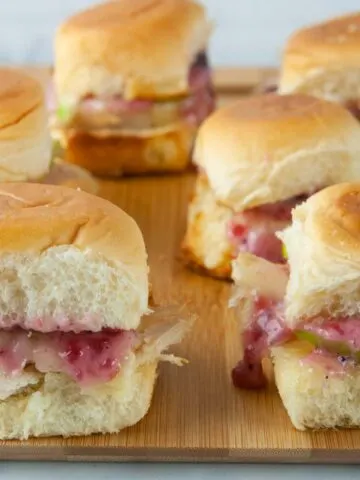 Turkey sliders on Hawaiian rolls are loaded with cranberry mayo, sharp cheddar and tart apple slices for a yummy way to use up holiday leftovers.