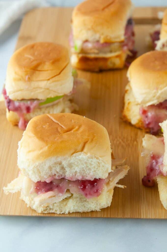 Turkey sliders on Hawaiian rolls are loaded with cranberry mayo, sharp cheddar and tart apple slices for a yummy way to use up holiday leftovers.