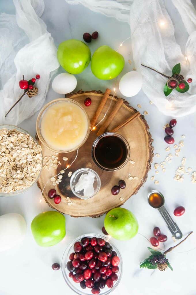 Ingredients for Cranberry Apple Baked Oatmeal: Apples, Cranberries, Eggs, Oats, Coconut Oil, Maple Syrup, Vanilla, Spices, and Milk