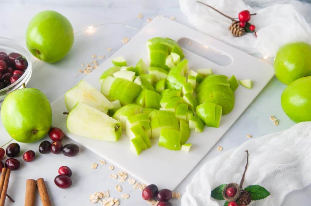 Dice the apples for baked oatmeal with cranberries and apples.