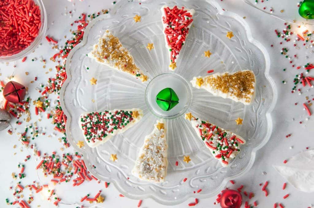 Festive sprinkles decorate homemade white chocolate Christmas trees 