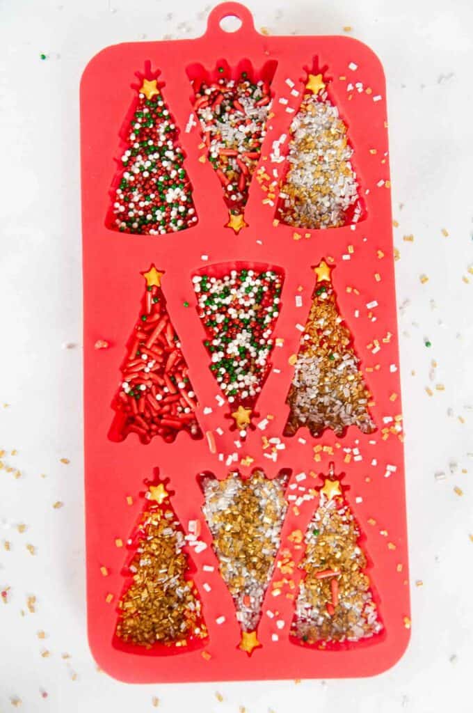Add sprinkles to the bottom of the silicone molds.