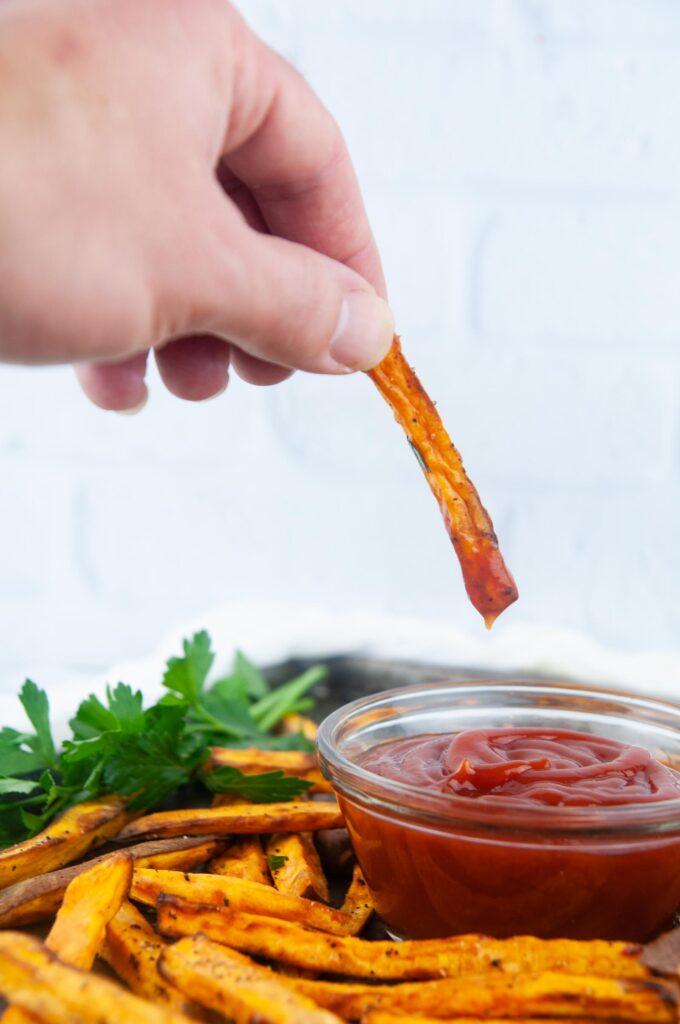 Baked Sweet Potato Fries dunked in ketchup make a yummy, kid friendly side dish.