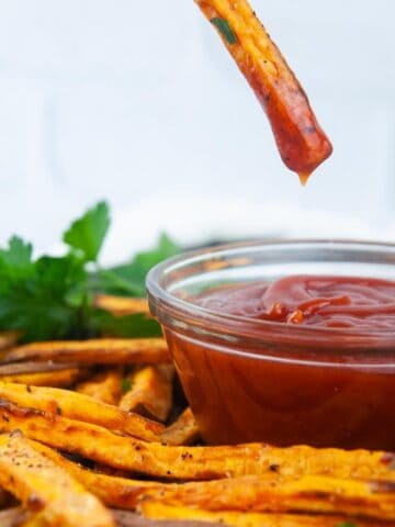 Baked Sweet Potato Fries dunked in ketchup make a yummy, kid friendly side dish.