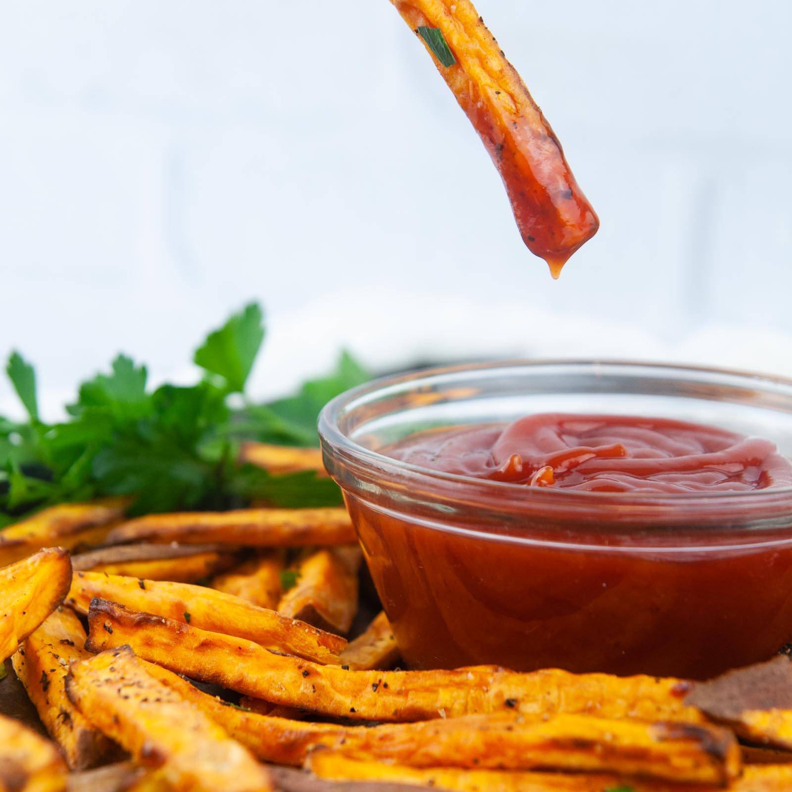 Baked Sweet Potato Fries dunked in ketchup make a yummy, kid friendly side dish.