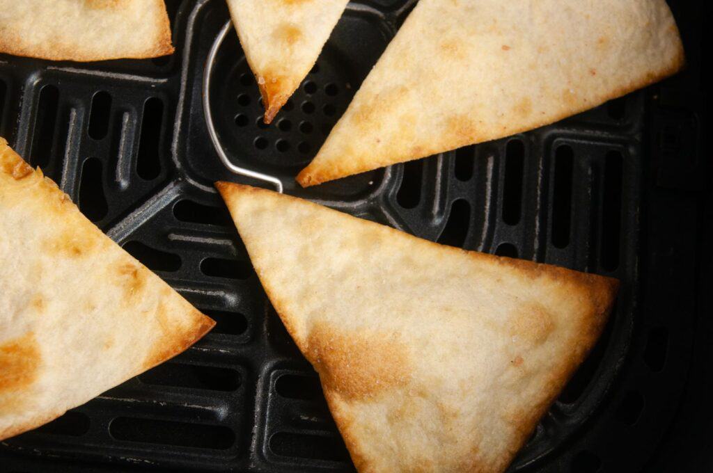 Air Fryer Tortilla Chips in the basket of the air fryer.