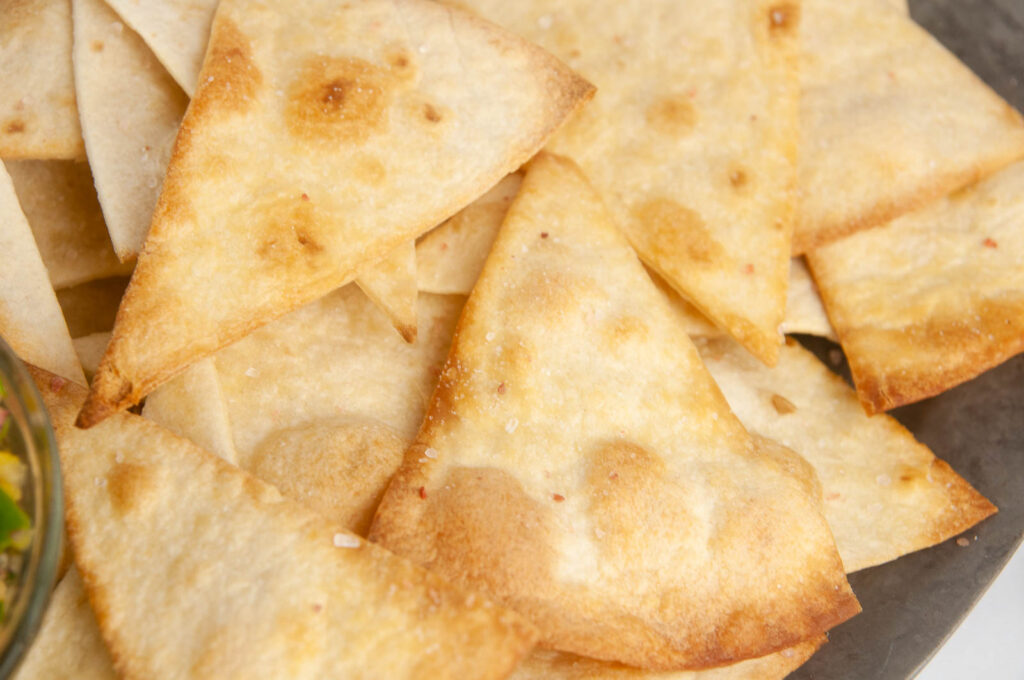 Learn how to make tortilla chips in the air fryer and the oven for a lighter way to satisfy your snack cravings.