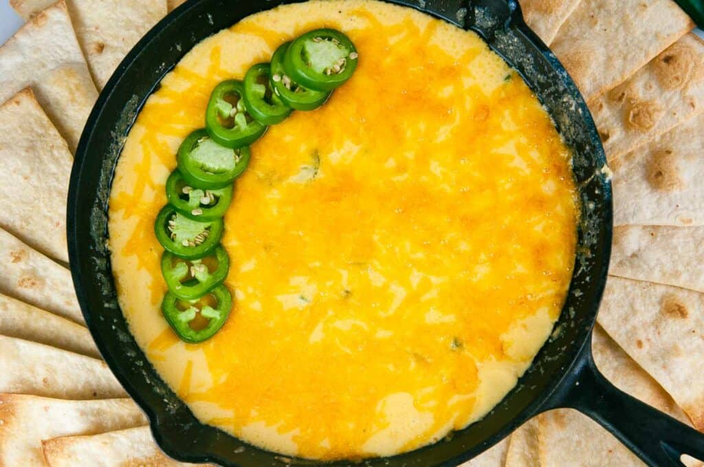 Jalapeno popper dip surrounded by crisp tortilla chips