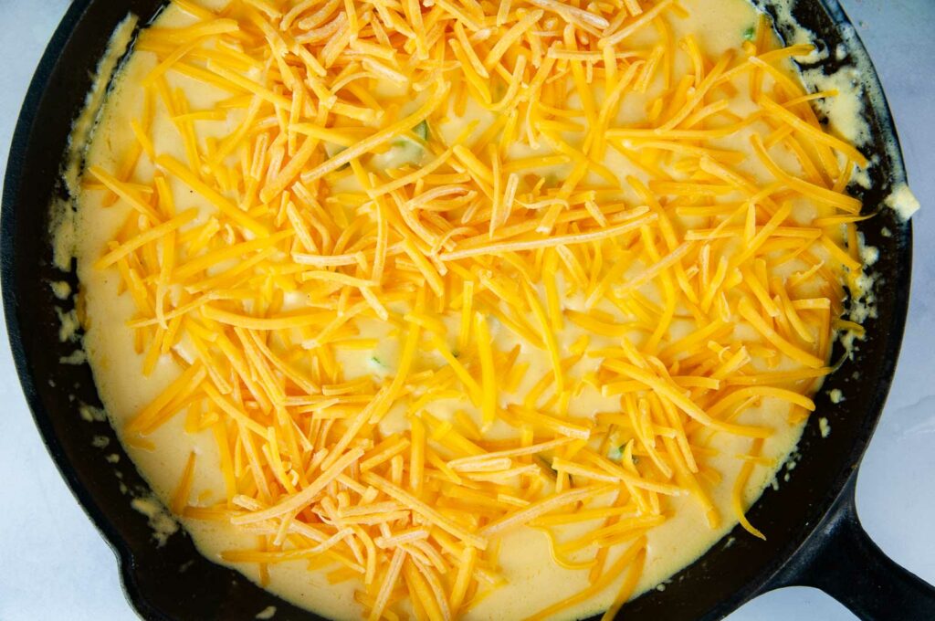 Top the jalapeno dip with the remaining cheddar cheese and pop it into the broiler.