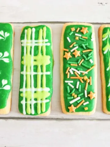 A spread of St. Patrick's Day Sugar Cookies decorated in different designs with royal icing