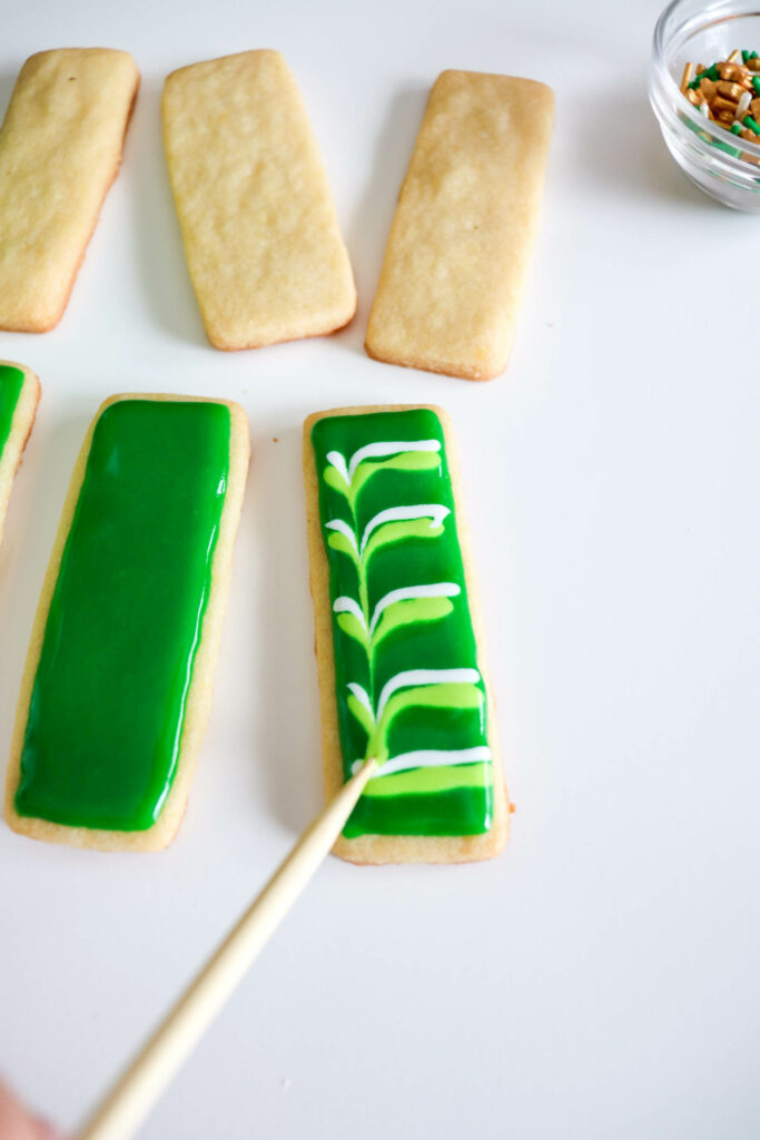 Make the zigzag by dragging a toothpick through the wet icing stripes