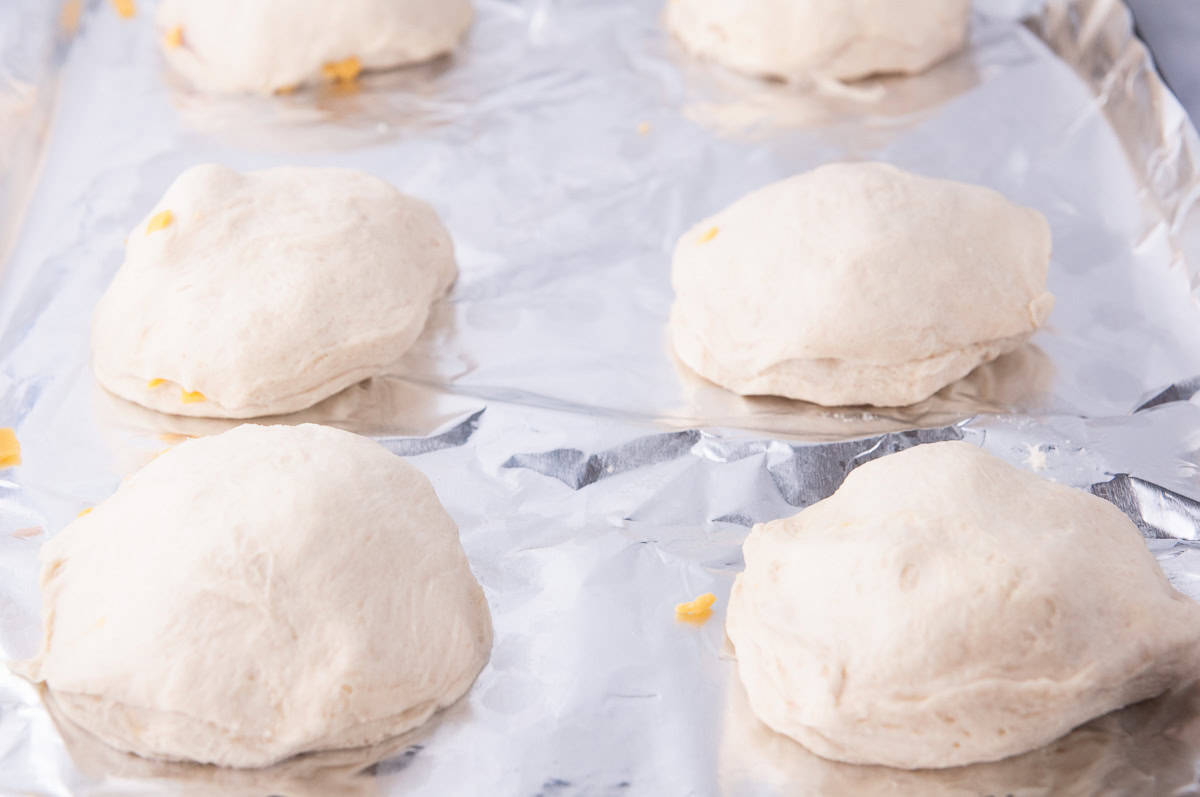 Press the edges of the biscuits together to make a sealed pouch of ham and cheese.