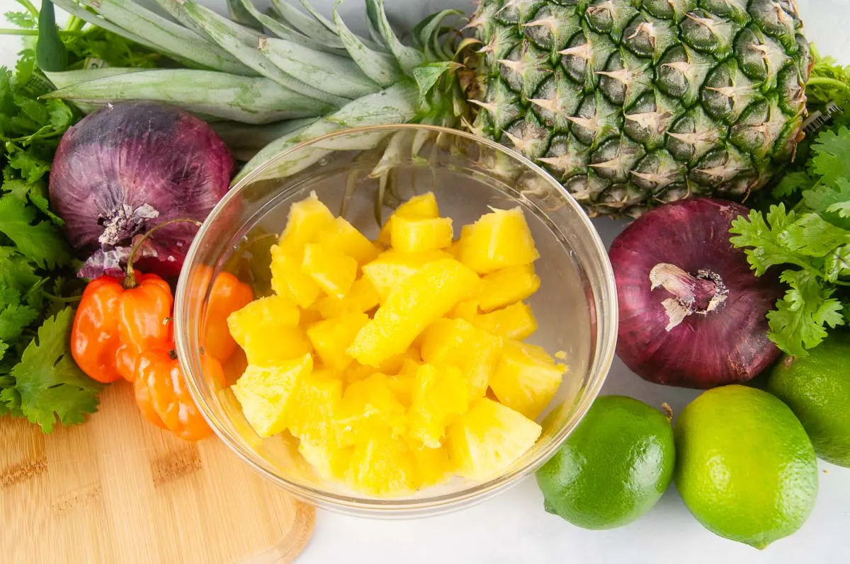 Ingredients for pineapple habanero salsa: pineapple, cilantro, red onion, habanero, lime
