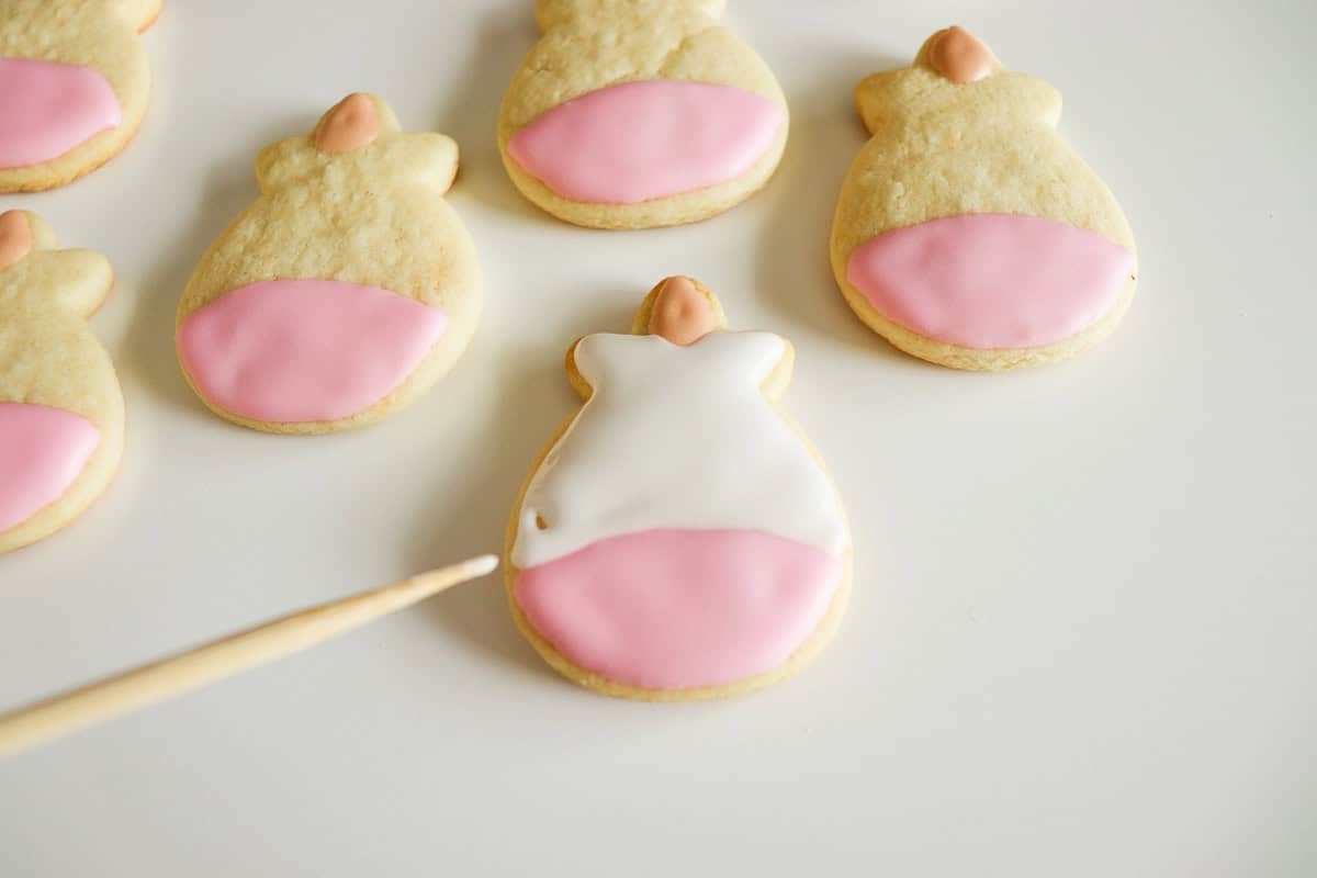 Use a toothpick to coax the icing into corners and pop air bubbles