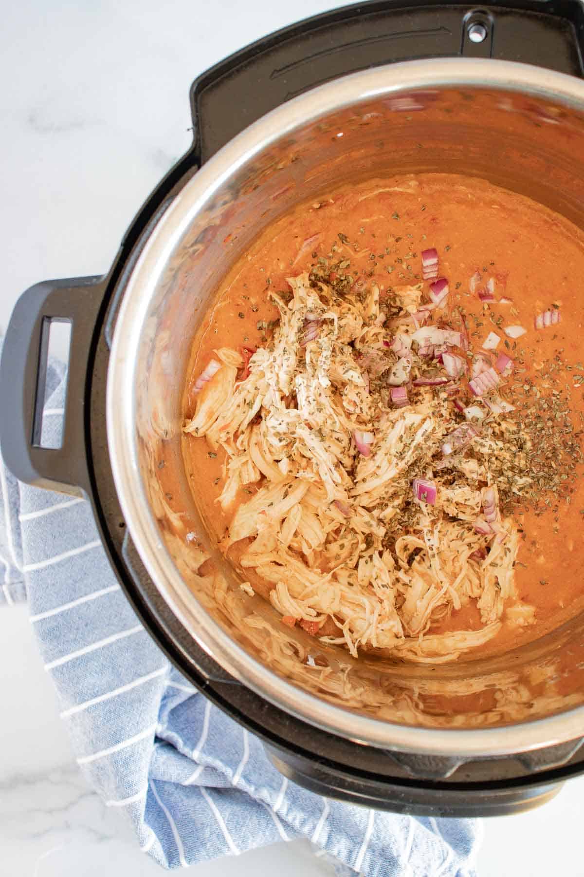 Shred the Thai chicken and return it to the Instant Pot.