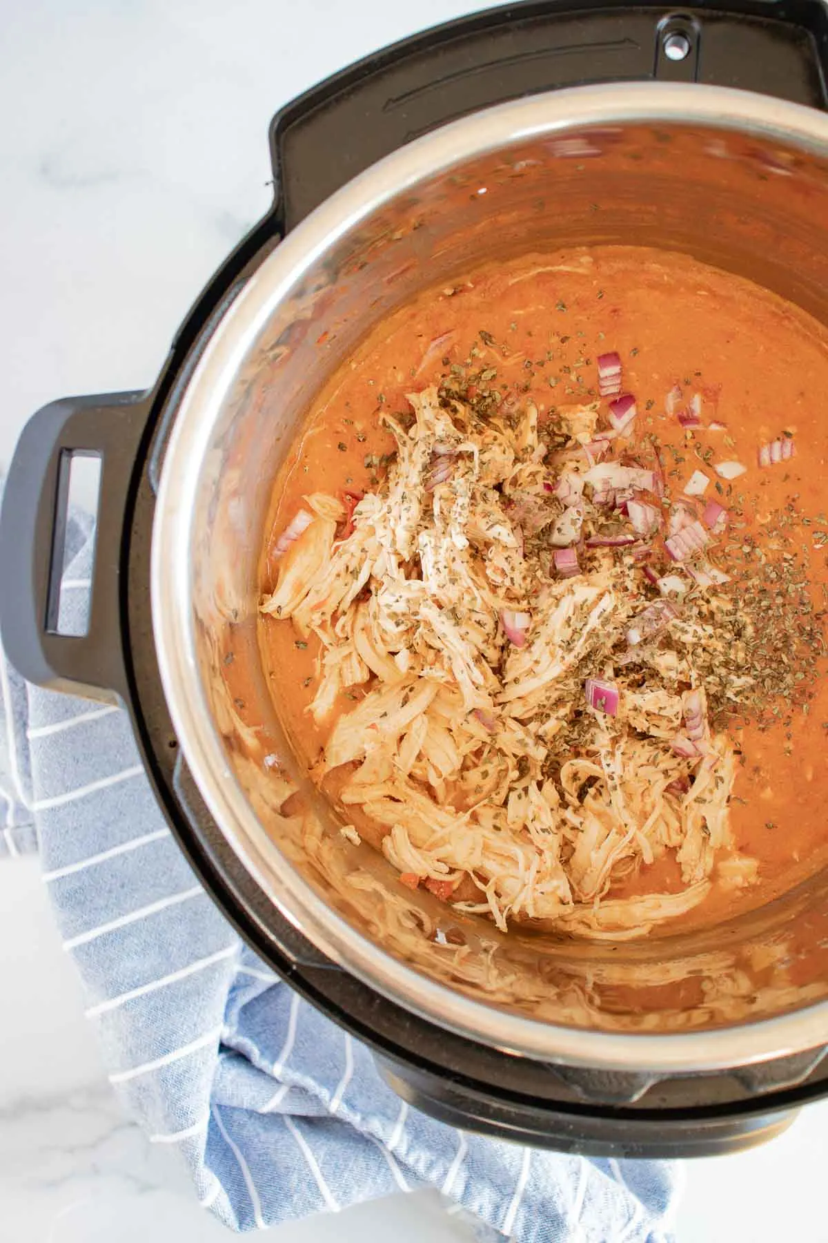 Shred the Thai chicken and return it to the Instant Pot.
