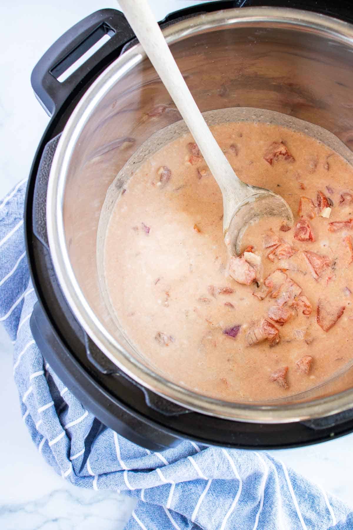 Stir together all the ingredients except the chicken in the inner liner of the Instant Pot.