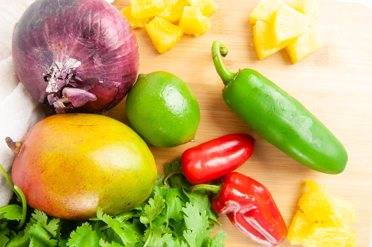 Ingredients for Pineapple Mango Salsa: Pineapple, Red Onion, Mango, Cilantro, Jalapeno, Sweet Peppers