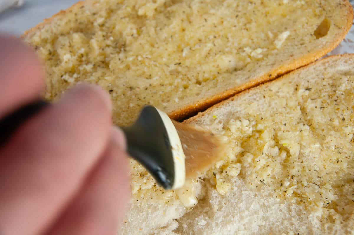 Brush the garlic herb butter onto the sliced bread