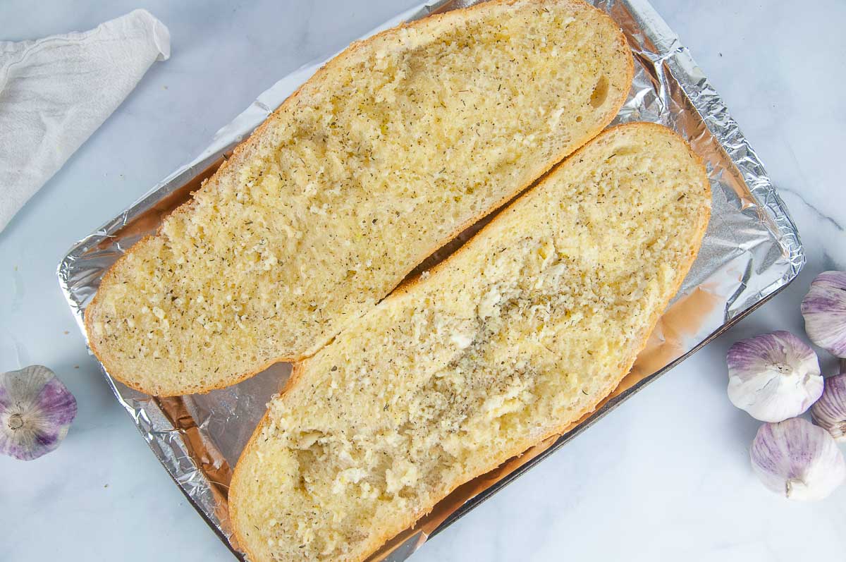 Bake the garlic bread in the oven.