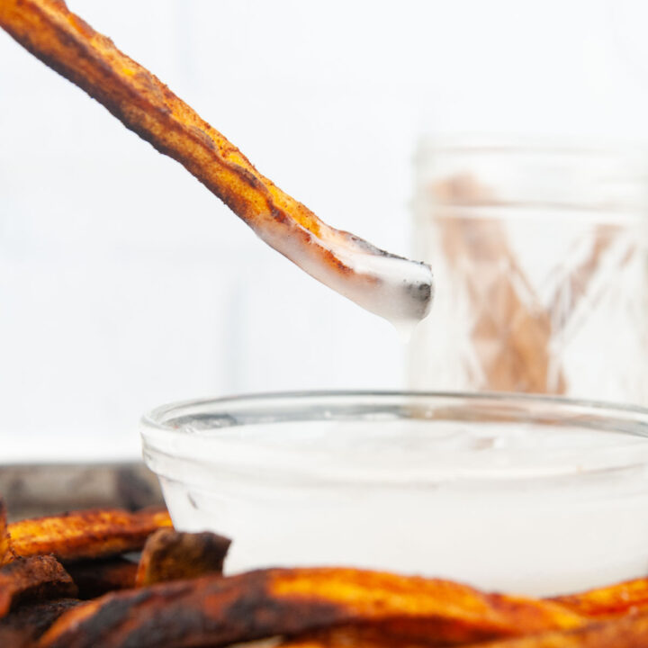 Cinnamon sugar sweet potato fries dipped into vanilla glaze