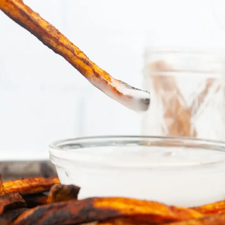 Cinnamon sugar sweet potato fries dipped into vanilla glaze