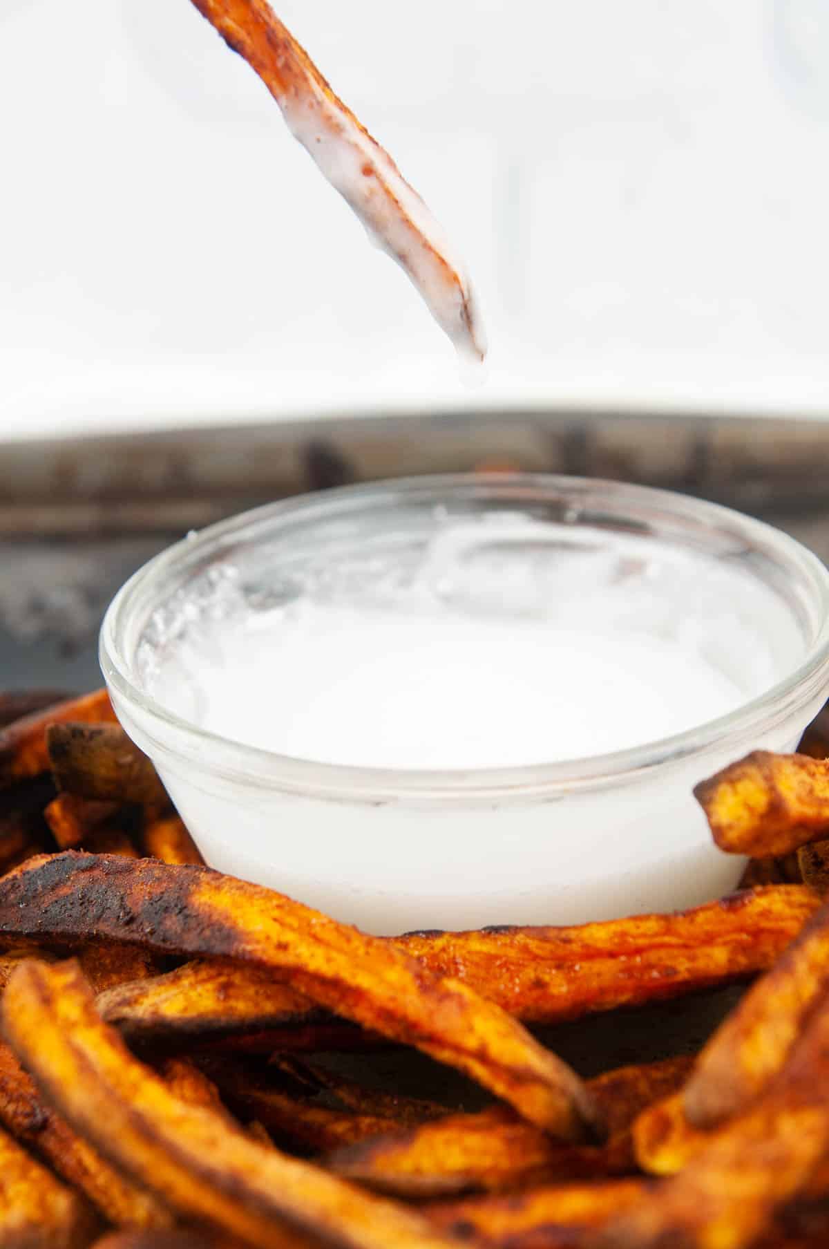 A cinnamon sugar fry dipped into powdered sugar dipping sauce 