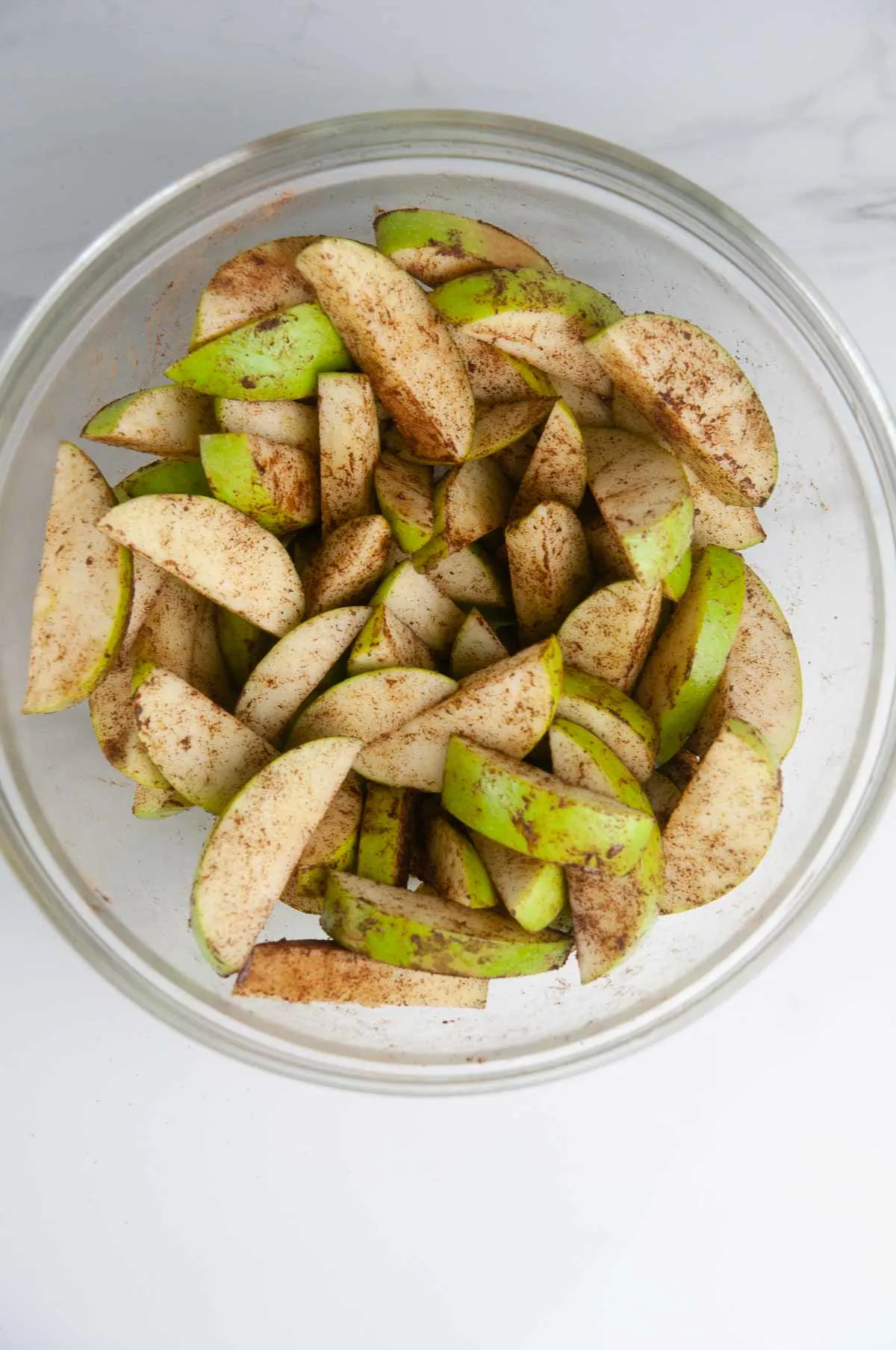 Toss the sliced apples with melted butter and cinnamon.